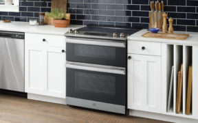 Kitchen with white cabinets and GE double range oven