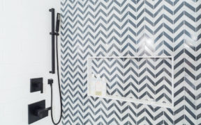Shower with black matte hardware and decorative tiling