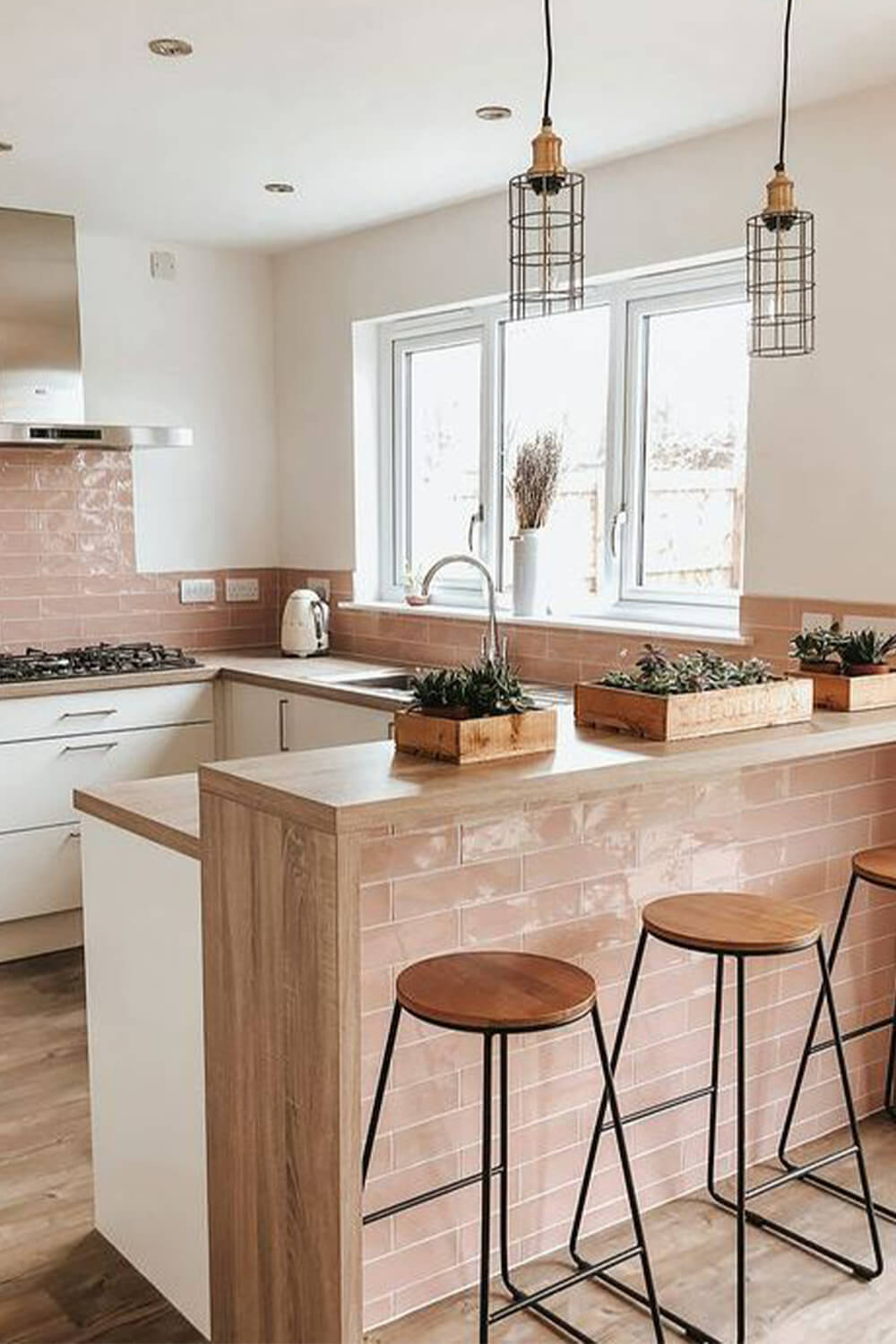 kitchen with multi-tier peninsula bar and pink tile