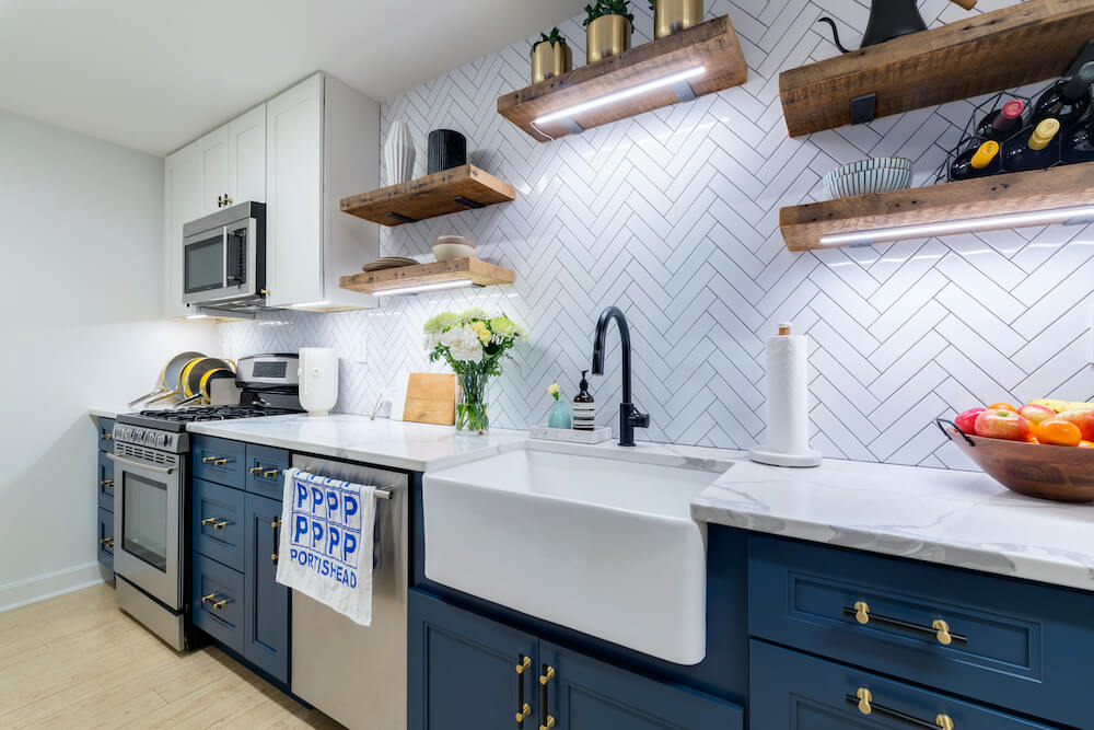 Kitchen with blue cabinets and chevron backsplash