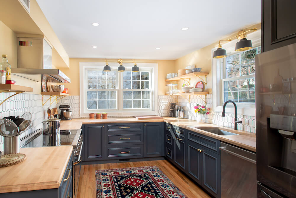 Kitchen with black shaker cabinets and yellow walls