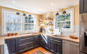black kitchen cabinets and maple countertops