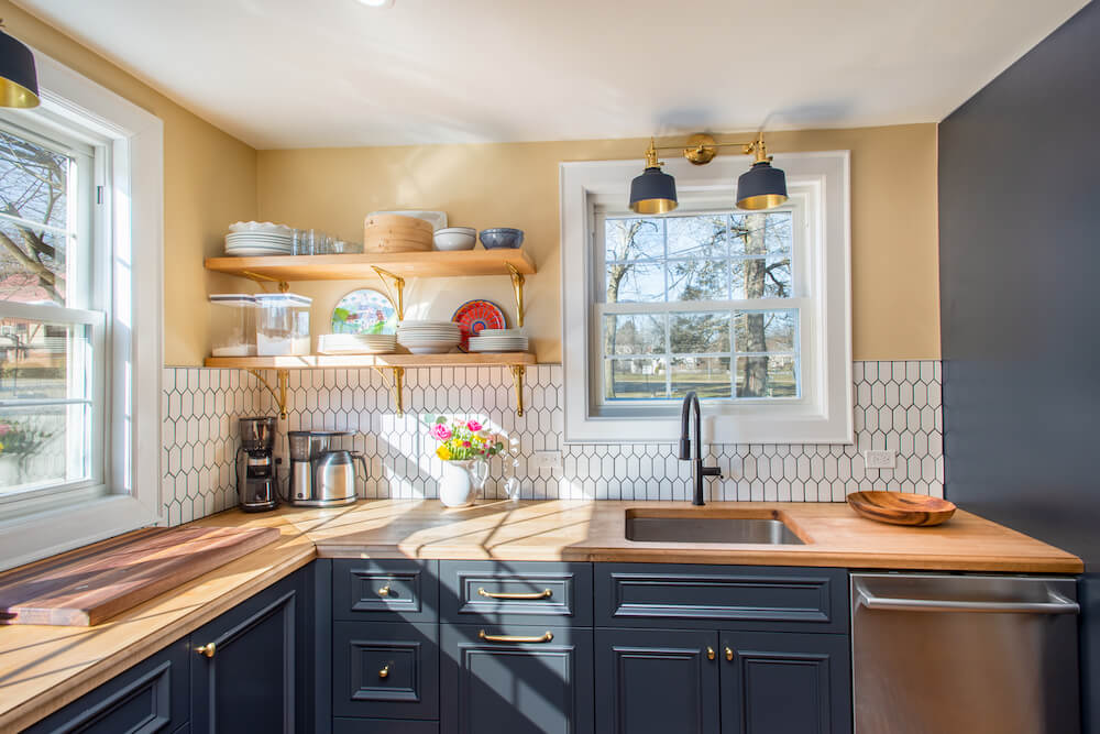 A Country Kitchen Remodel With Black Cabinet Paint