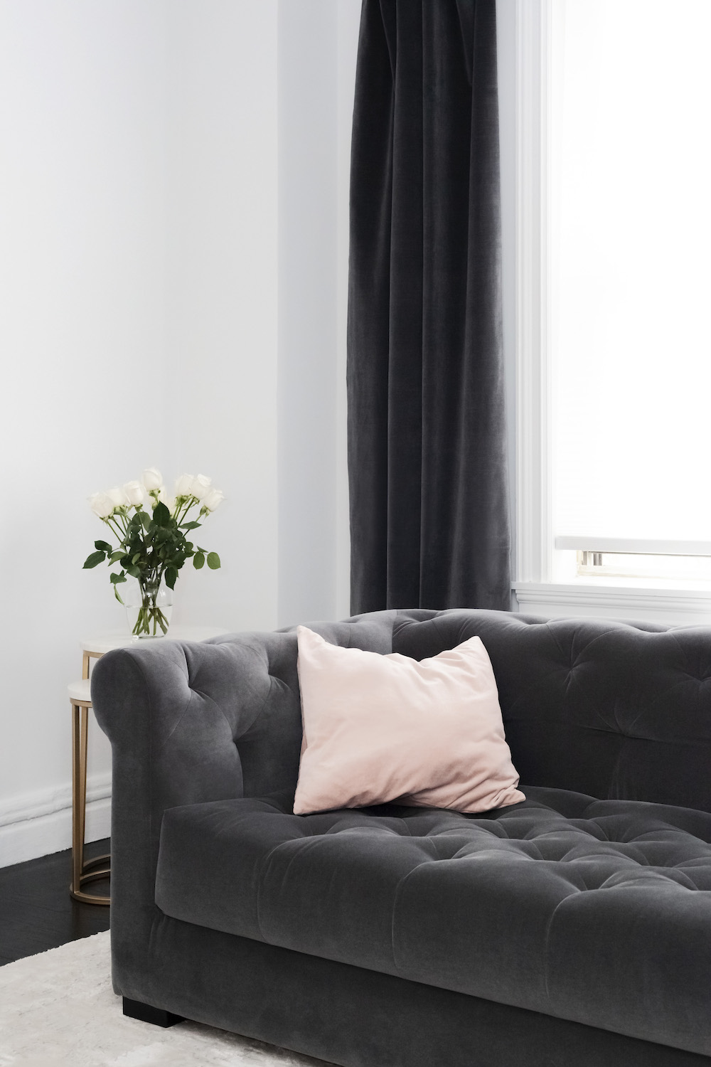 Gray velvet couch and curtains