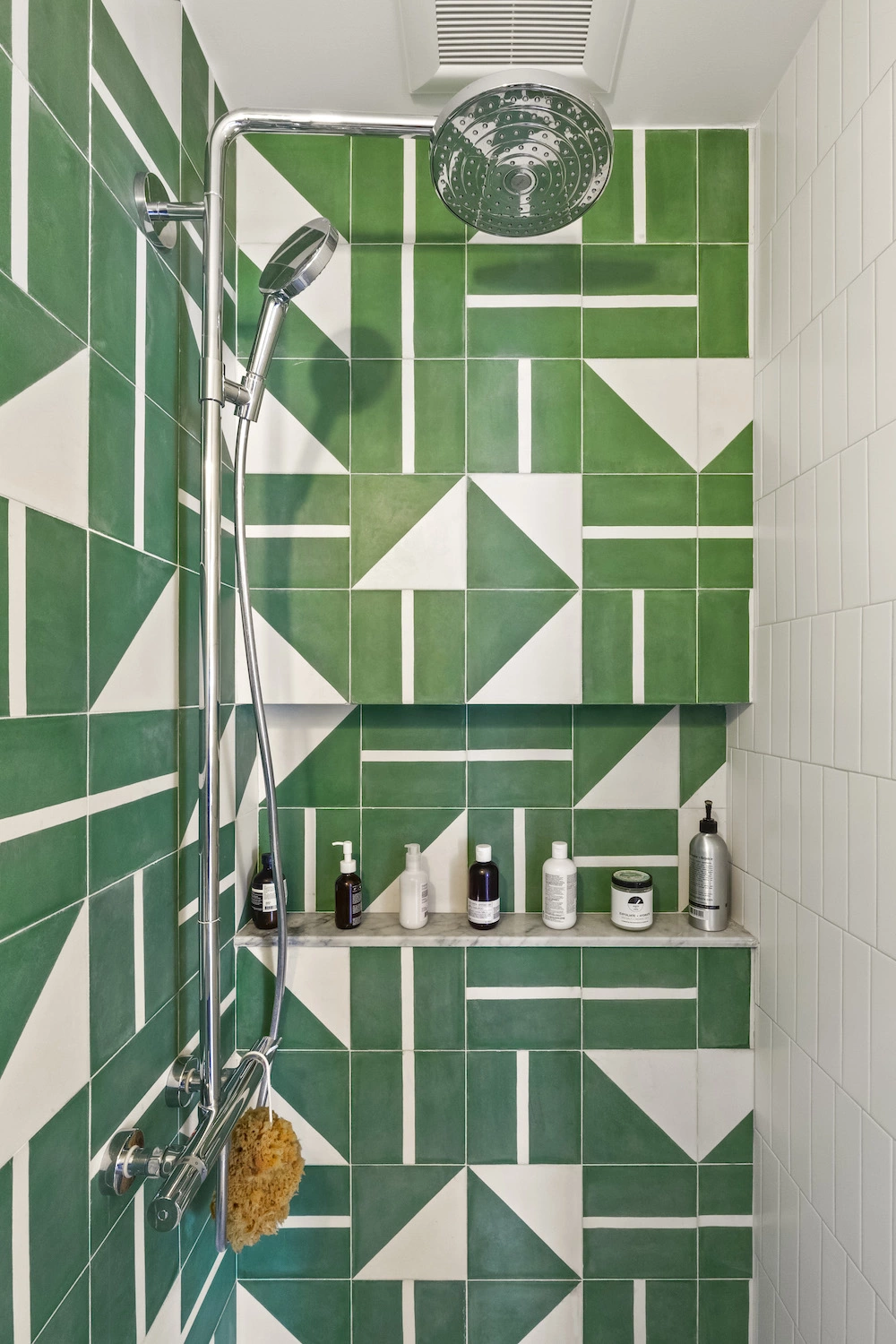 Shower with green and white patterned tile