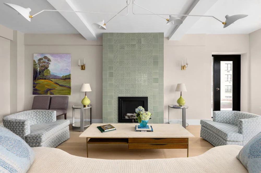 Living room with green tiled fireplace in apartment remodel on the Upper West Side