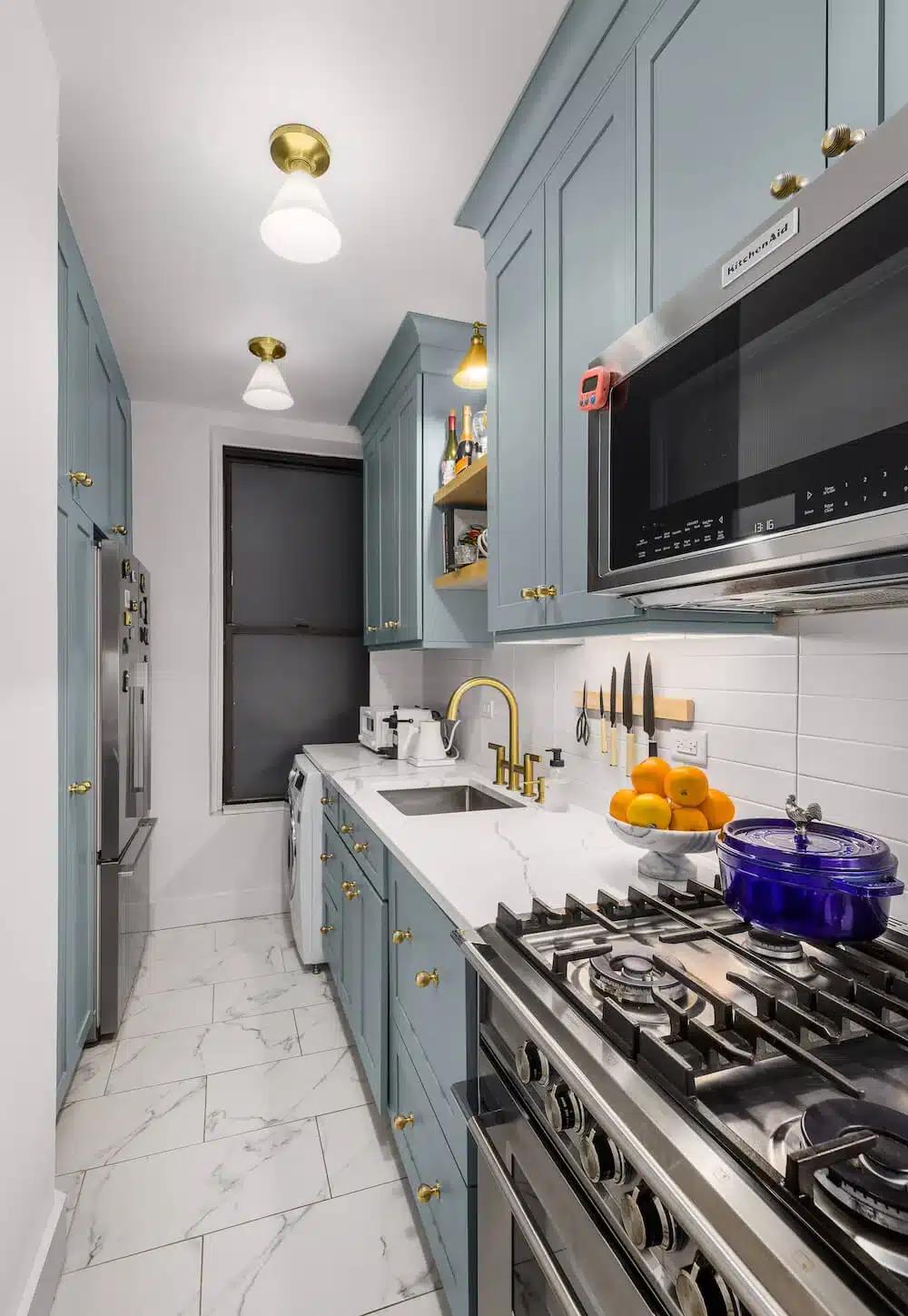 blue galley kitchen apartment remodel on the Upper East Side