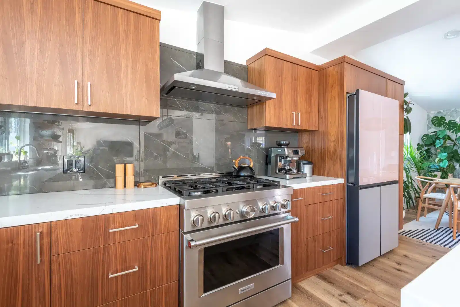 wood kitchen with black quartzite backsplash and Bespoke Flex refrigerator