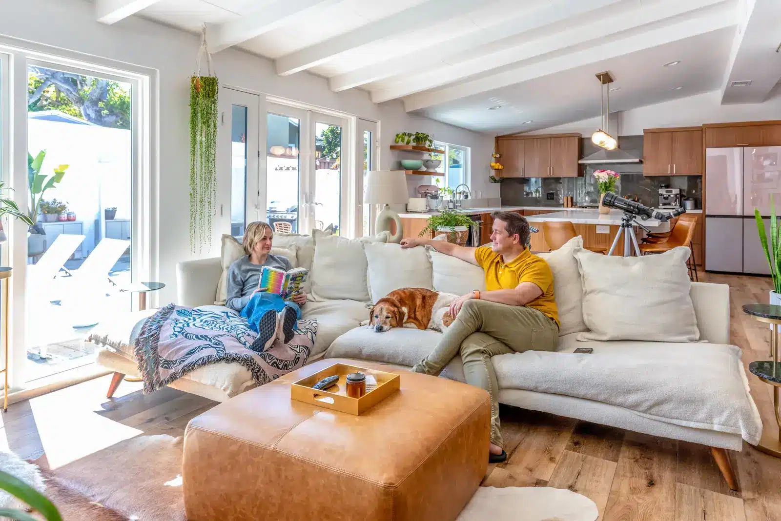 homeowners sitting on LR sofa after home remodel in culver city