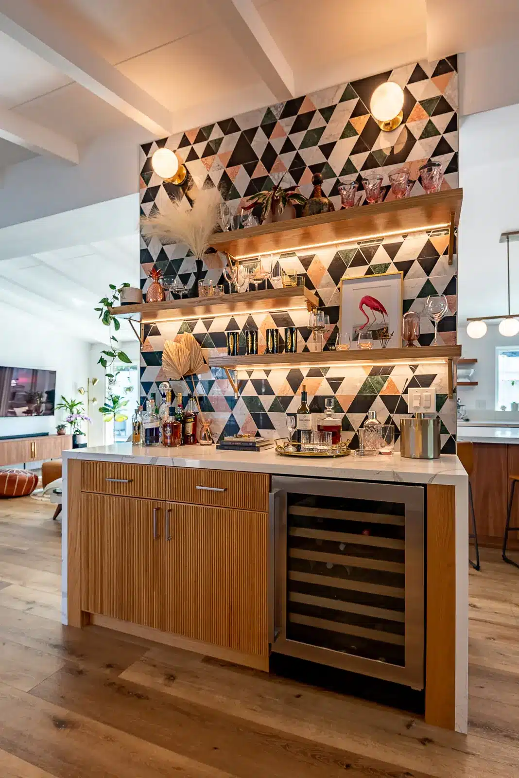 A kitchen bar with graphic backsplash and undercounter wine fridge