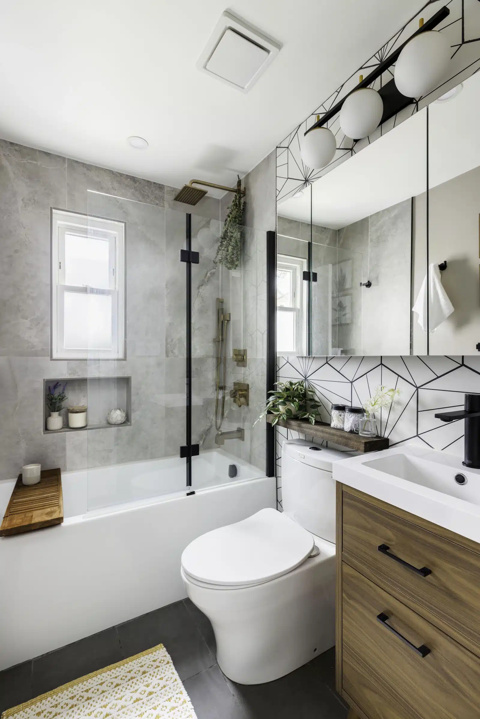bathroom with tub shower with beige stone and hex pattern tile in home remodel in rosedale