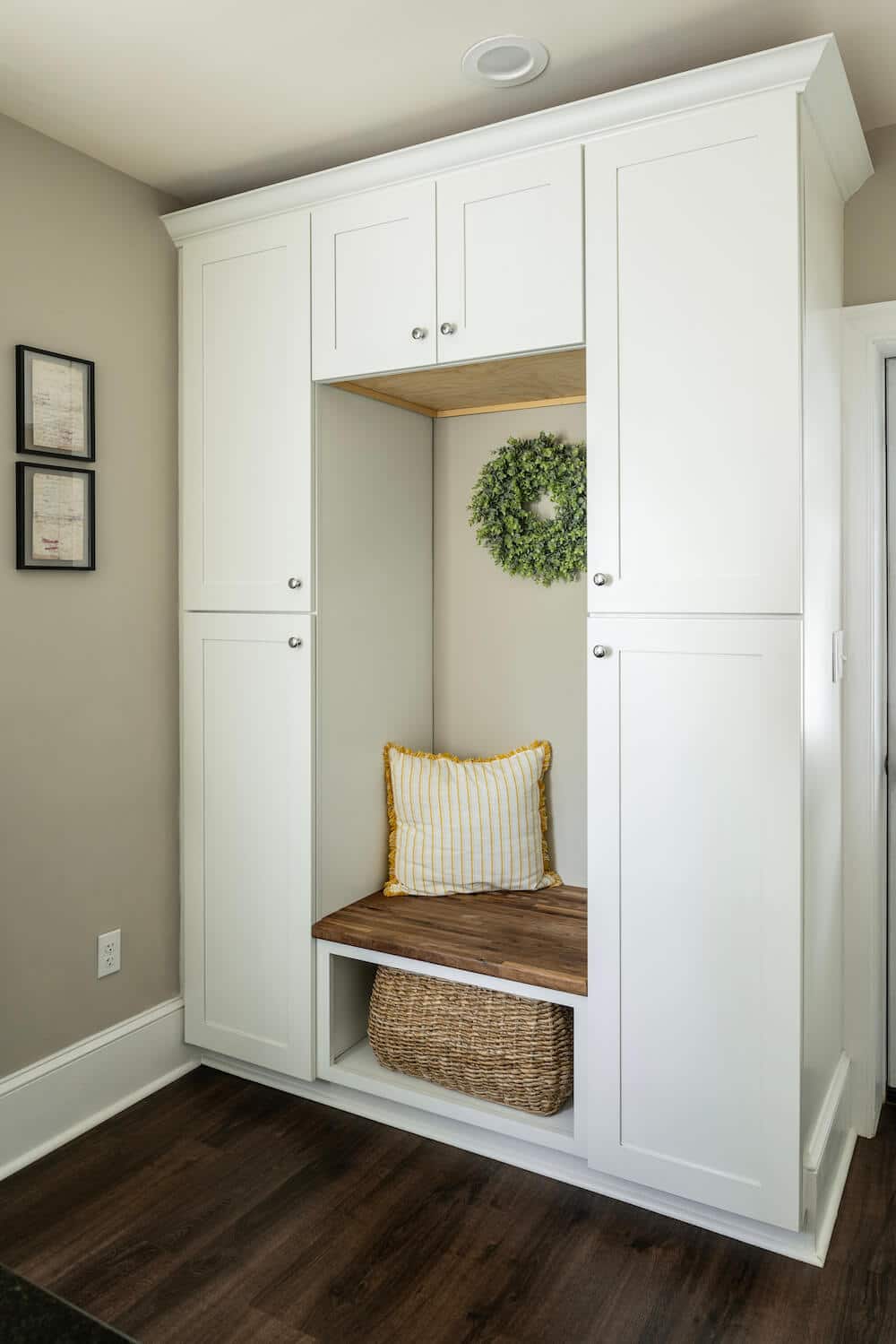 white built-in storage cabinet with seat