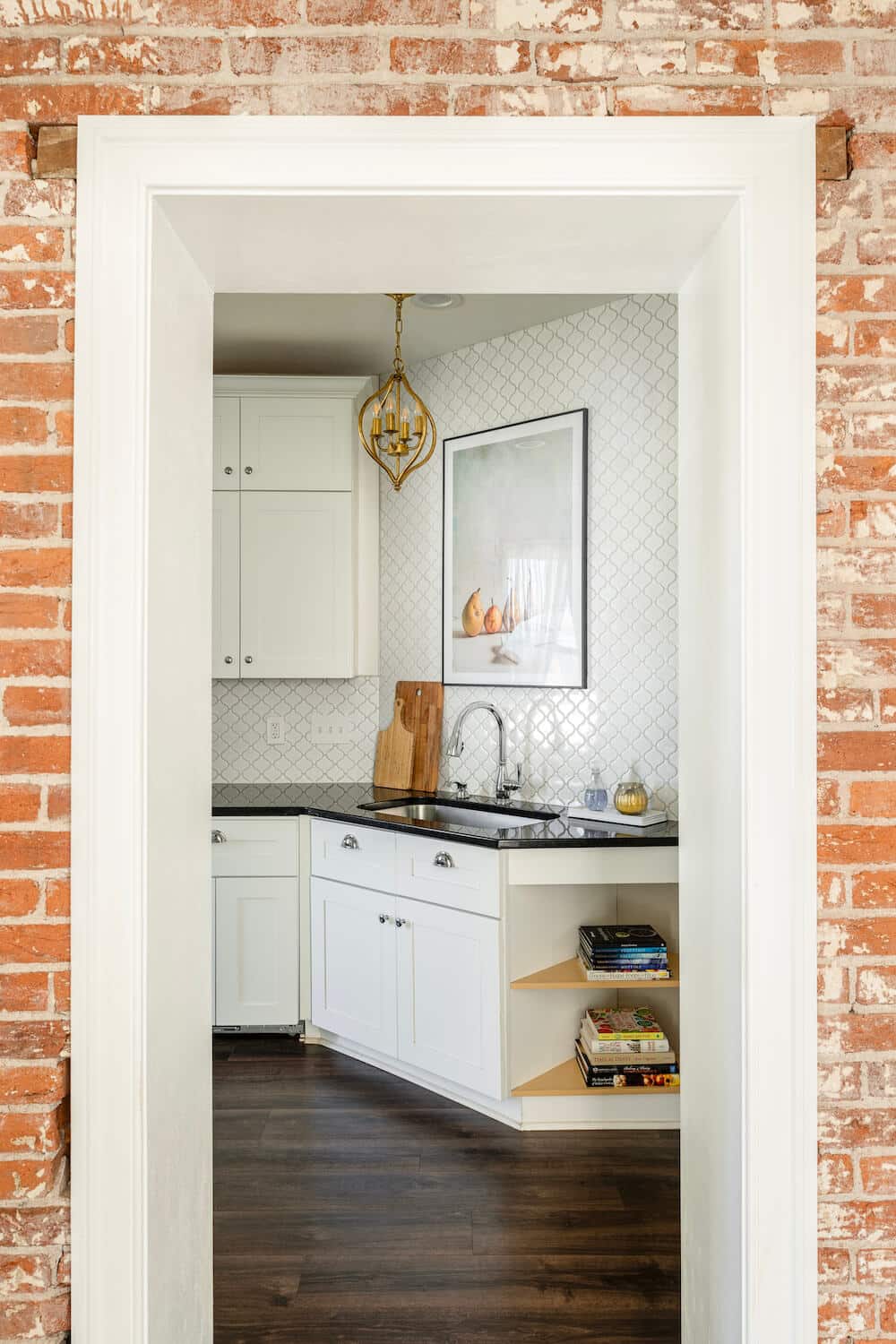 brick wall and kitchen counter endcap with open shelves