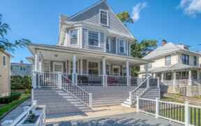 Exterior of a 1920s Pelham house with gable roof and porch, setting for an attic renovation that improved light, flow, and family living space.