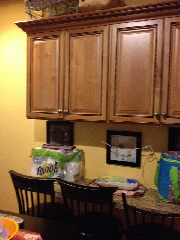Old kitchen with wood cabinets and table with chairs