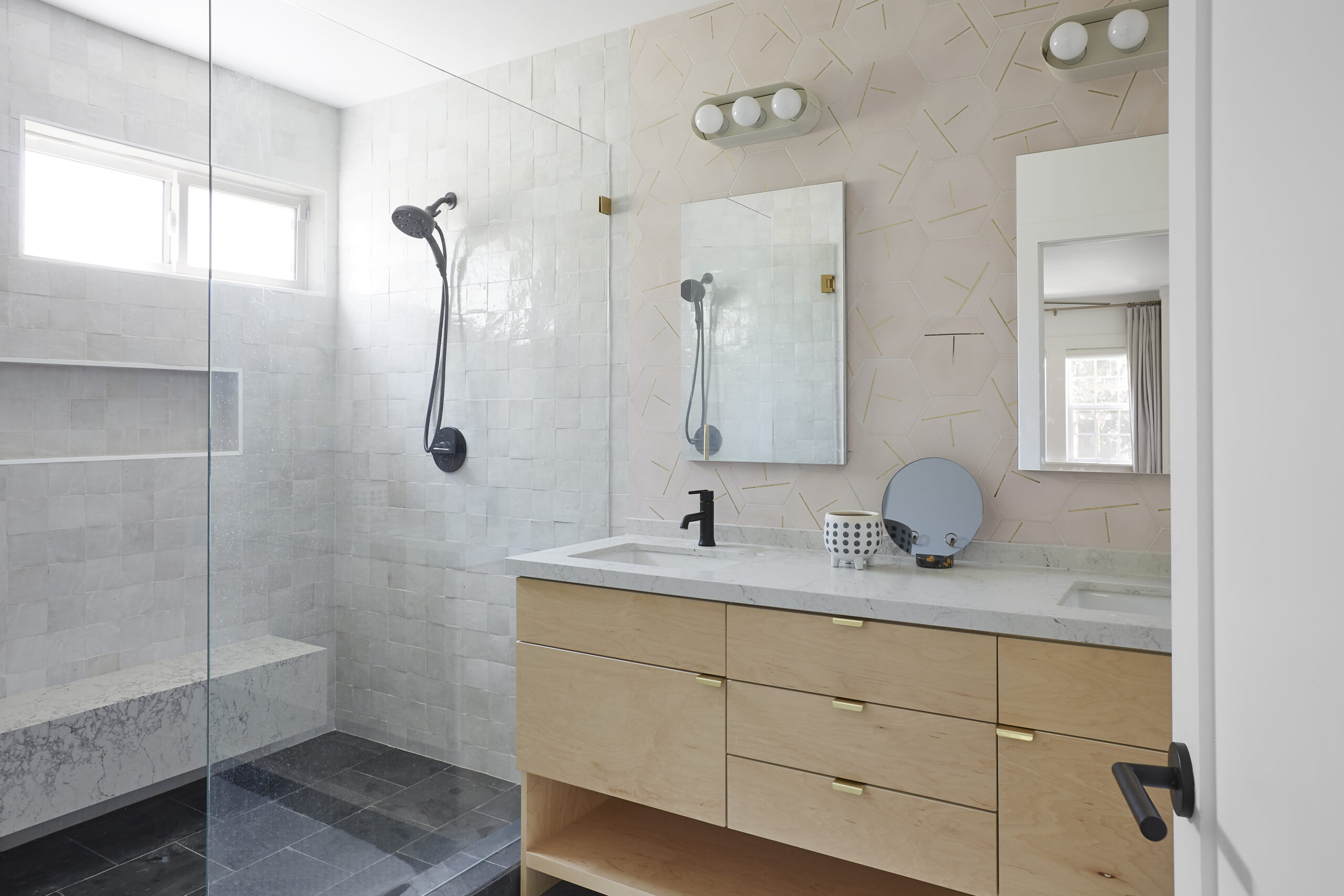 Zellige tile brightens actress Jaime Ray Newman’s bathroom, wrapping the shower and vanity wall in reflective neutrals with subtle brass accents