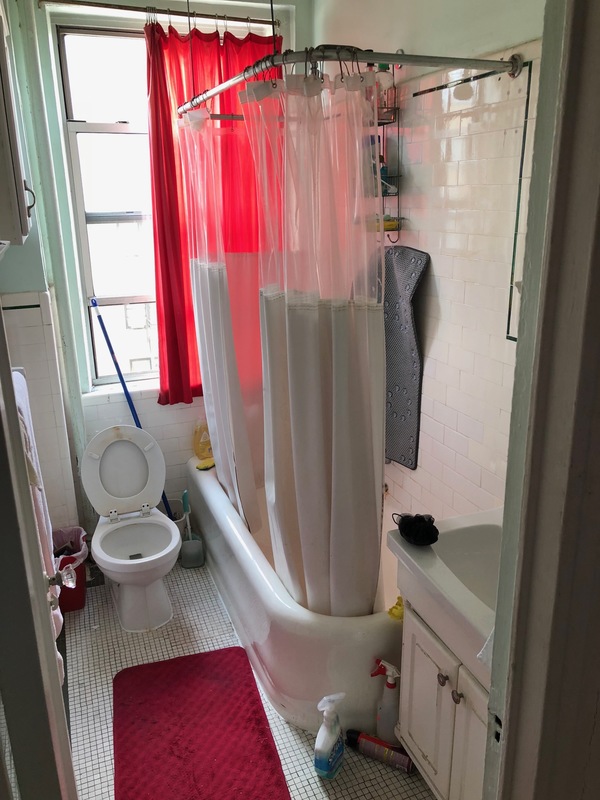 Before a bathtub to shower conversion with a white tub and toilet.