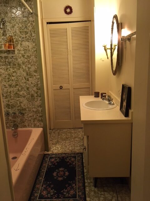 Narrow bathroom prior to tub to walk-in shower conversion.