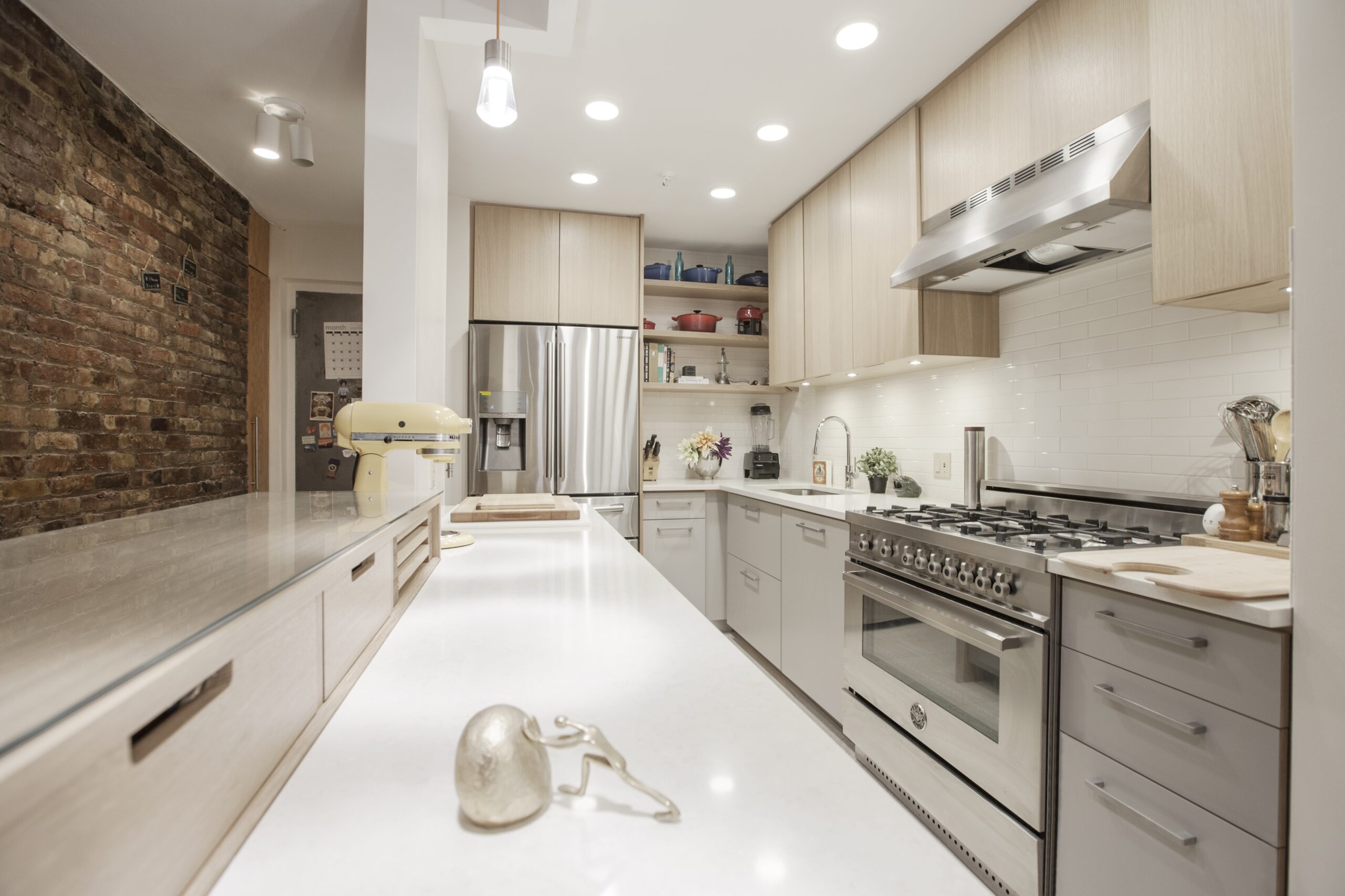 Kitchen wall with pro-style range and long prep counter; capacity suits holiday dinners, so hosts cook multiple dishes and still greet guests.