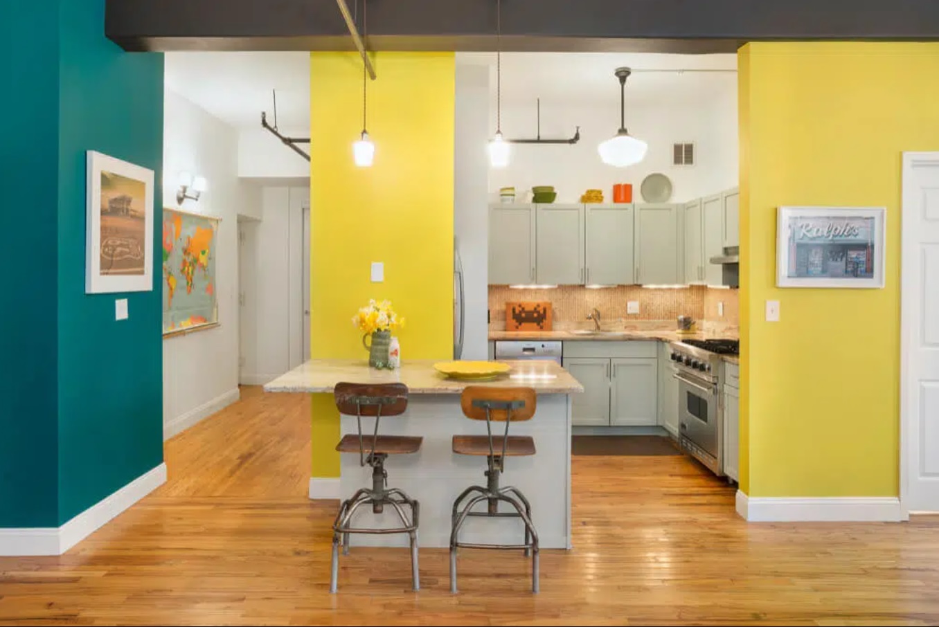 Kitchen with taupe color cabinetry, yellow and deep green walls, and wooden flooring