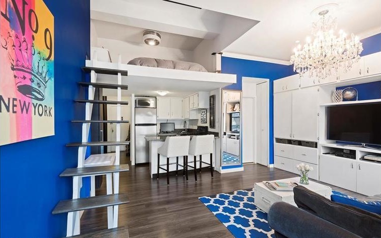 Before the studio loft renovation featuring a staircase without rails and an open bedroom