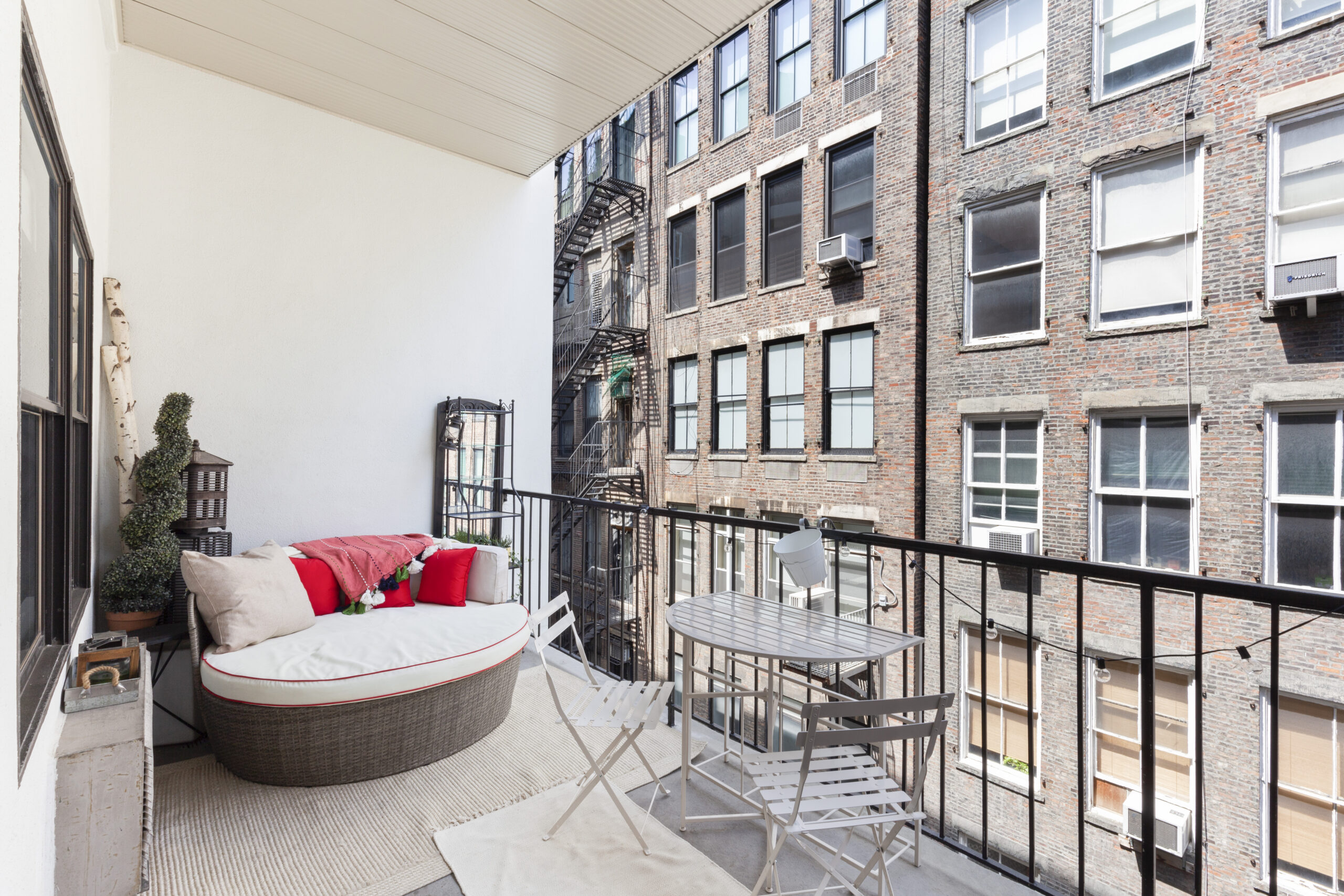 Studio loft balcony with comfortable seating overlooking NYC neighborhood
