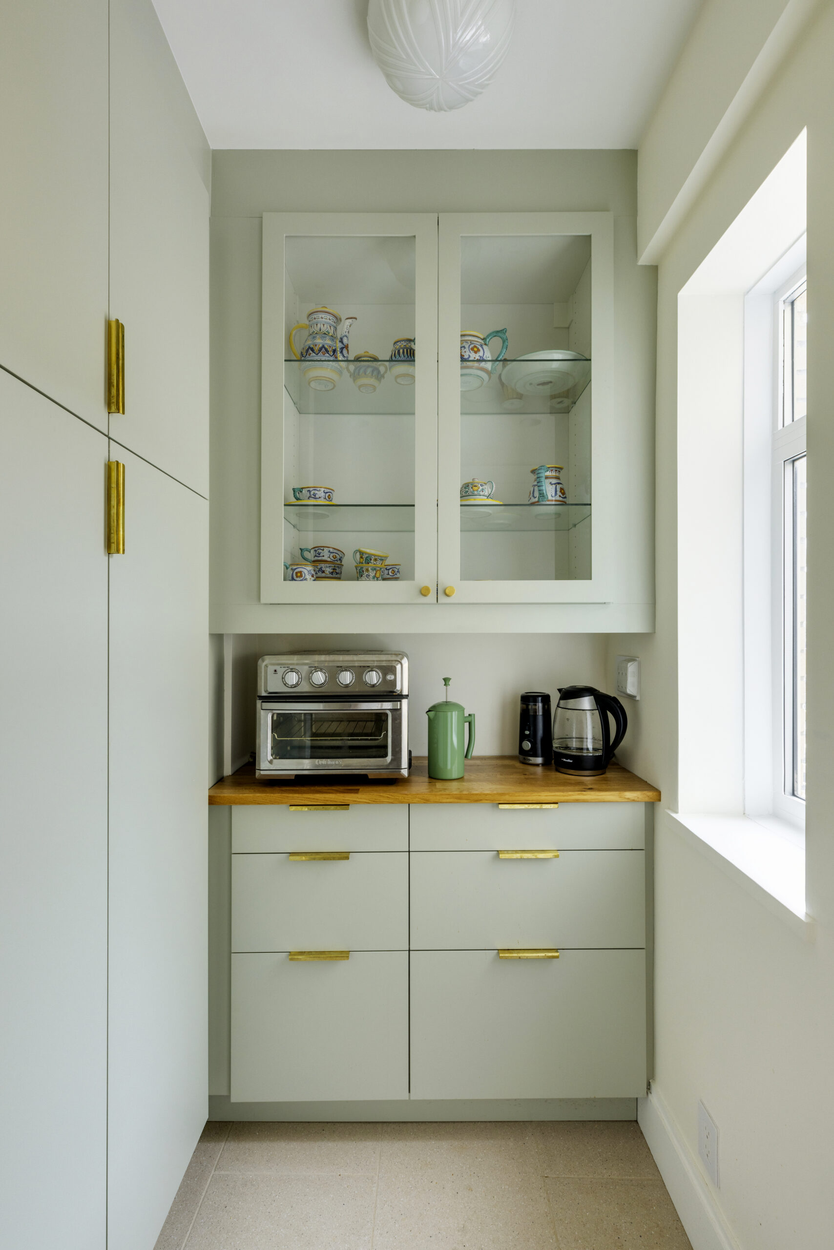 A new mint green kitchen featuring a pantry that serves as a coffee nook