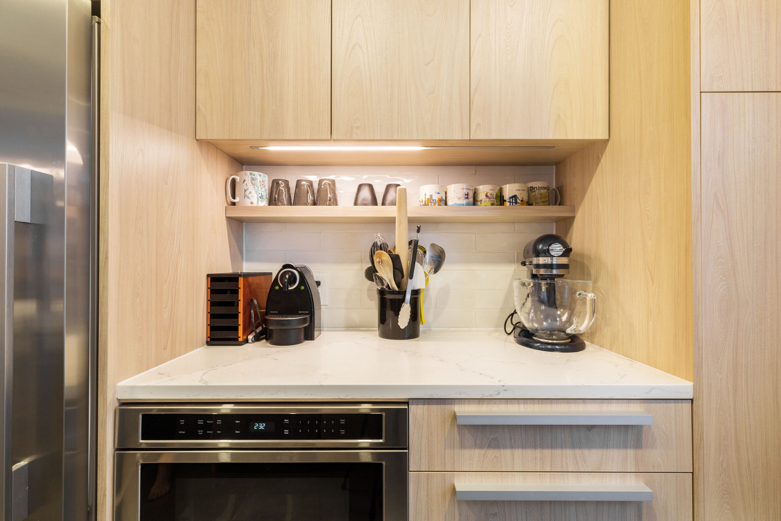 A remodeled kitchen with a dedicated counter and shelves for a coffee bar