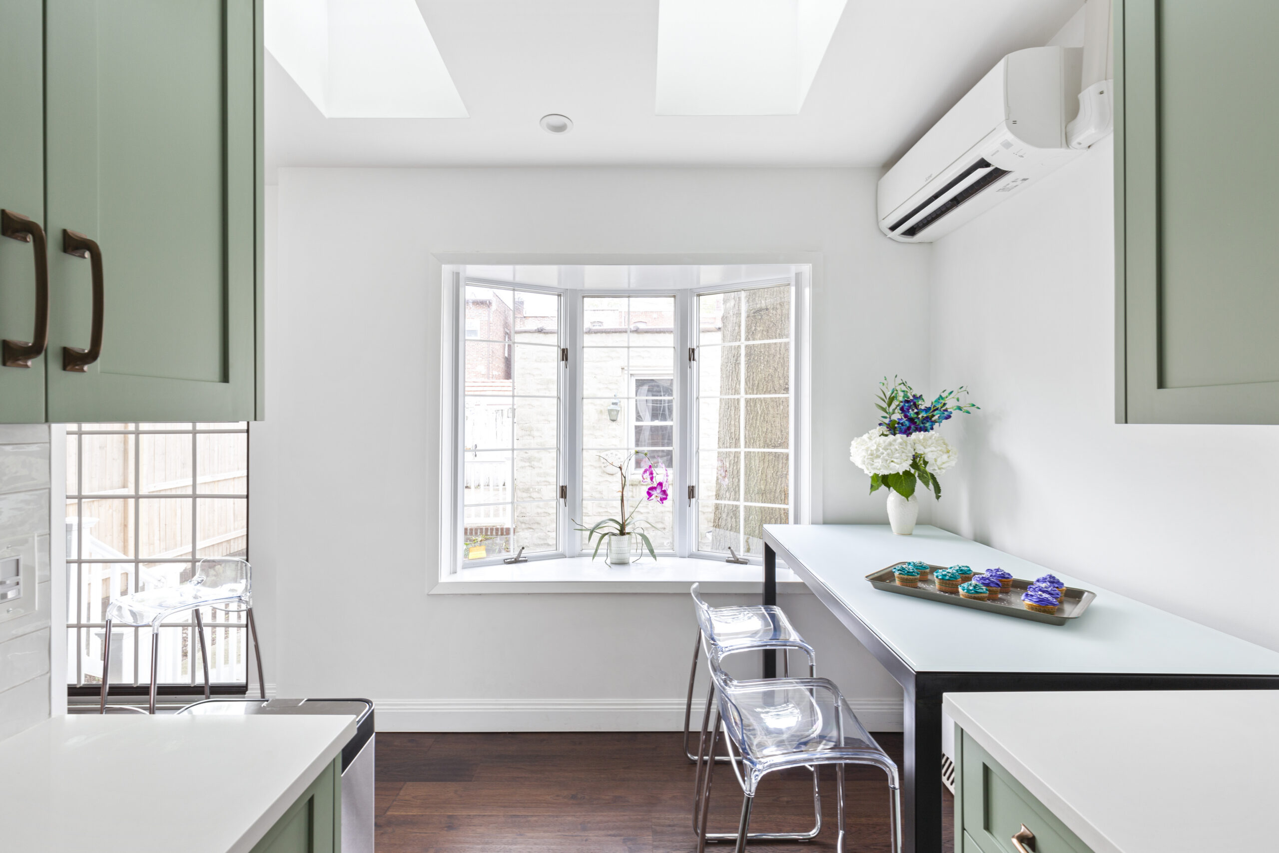 A rear kitchen extension with new windows and dining space that brought more light into her Queens townhouse